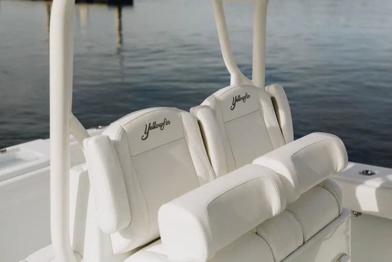Slide: The Image of 2023 Yellowfin 32 Offshore boat seats with embroidered logo, on calm water. - 18