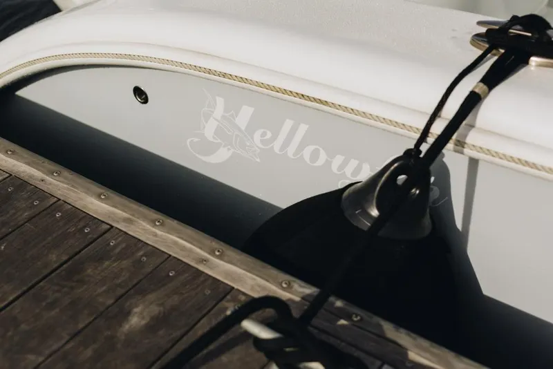 Slide: The Image of 2023 Yellowfin 32 Offshore boat docked with visible logo and fender. - 19