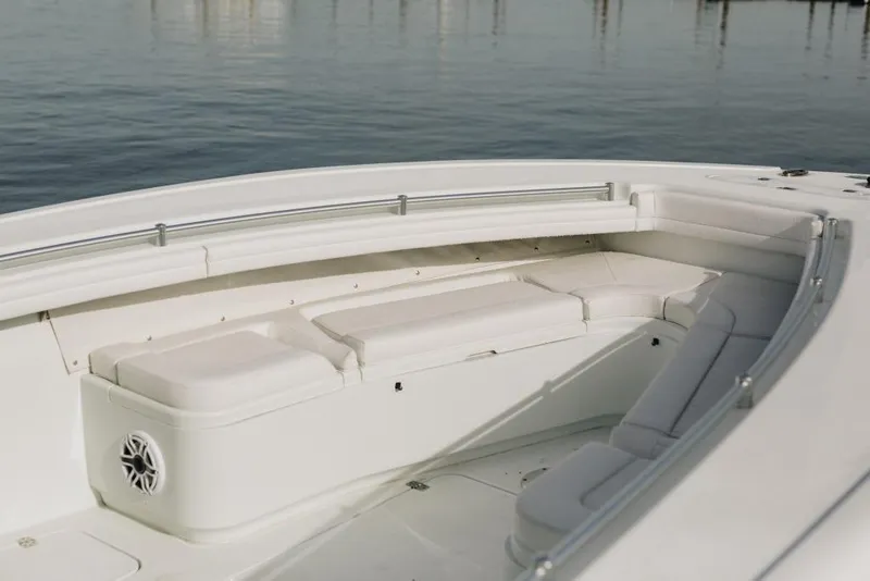 Slide: The Image of 2023 Yellowfin 32 Offshore boat interior with cushioned seating and stainless steel railings. - 22