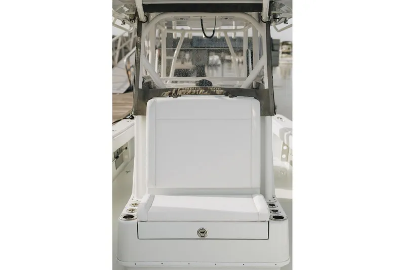 Slide: The Image of 2023 Yellowfin 32 Offshore boat interior with white seating and cup holders. - 5