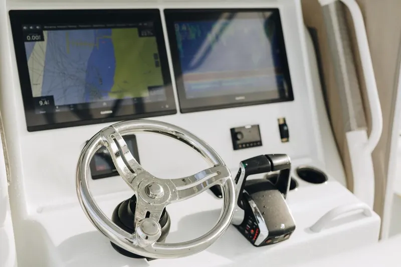 Slide: The Image of Steering console of 2023 Yellowfin 32 Offshore boat with dual navigation screens. - 8