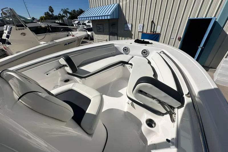 Slide: The Image of 2025 Tidewater 198 CC Adventure boat interior with white seating and speakers. - 11