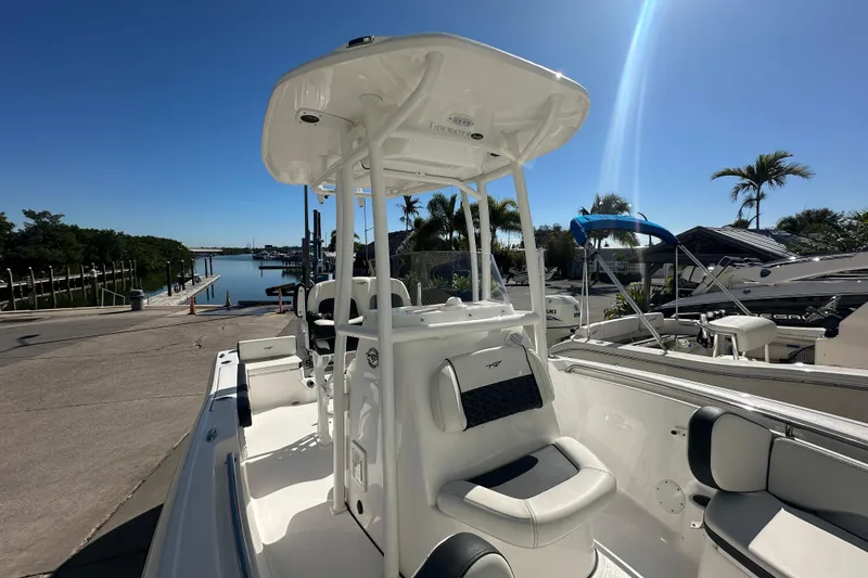 Slide: The Image of 2025 Tidewater 198 CC Adventure boat docked under clear blue sky. - 13