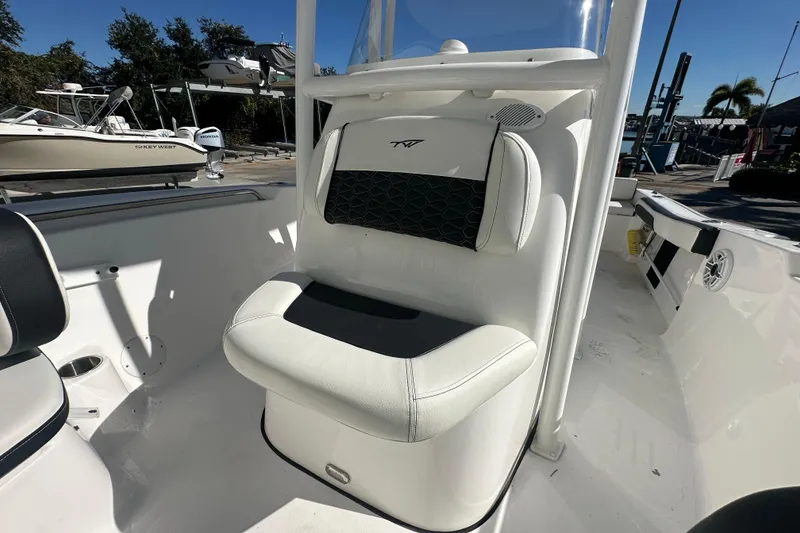 Slide: The Image of 2025 Tidewater 198 CC Adventure boat interior with white seating and black accents. - 15
