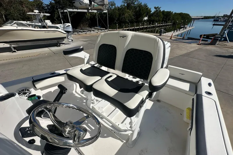 Slide: The Image of 2025 Tidewater 198 CC Adventure boat interior with dual seats and steering wheel. - 20