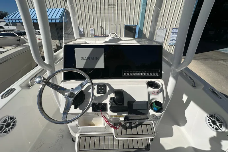 Slide: The Image of 2025 Tidewater 198 CC Adventure boat console with Garmin navigation system and steering wheel. - 21