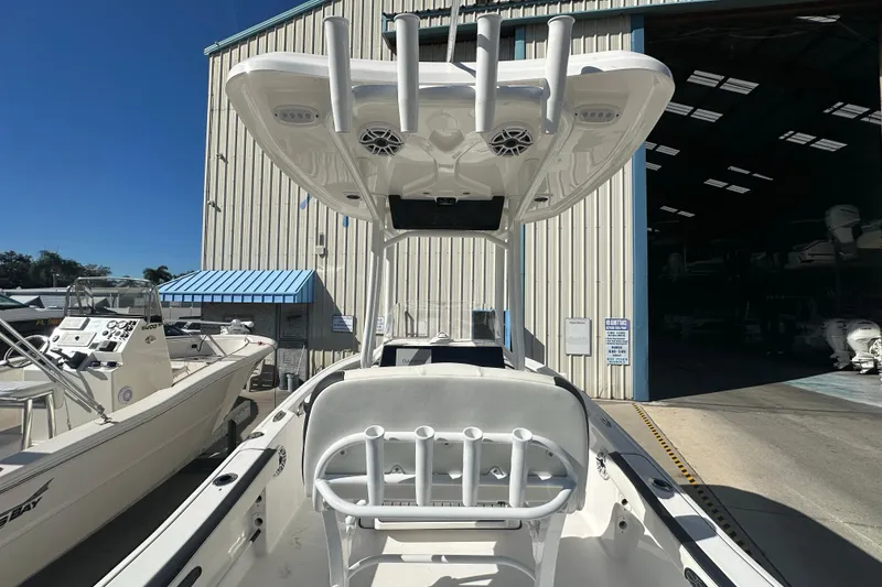 Slide: The Image of 2025 Tidewater 198 CC Adventure boat in marina, showcasing helm and seating area. - 22