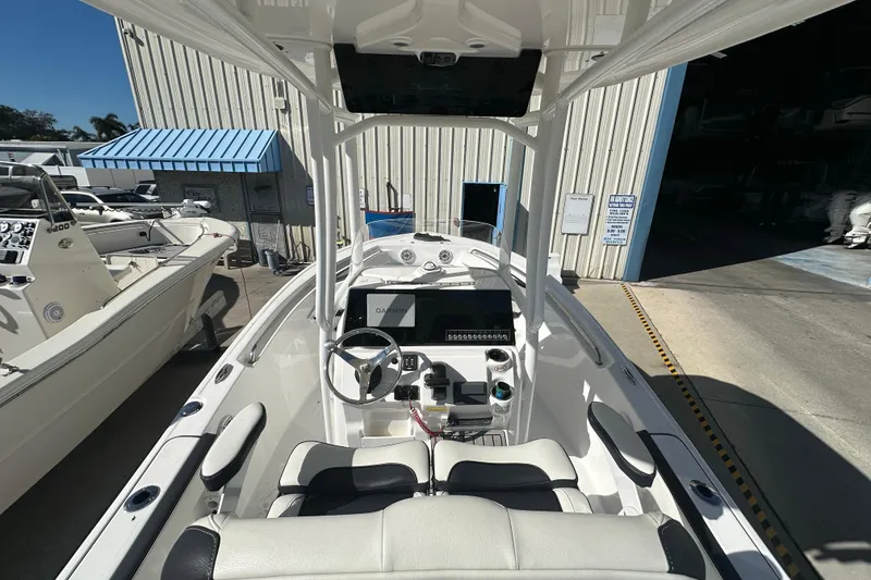 Slide: The Image of 2025 Tidewater 198 CC Adventure boat interior with steering wheel and Garmin display. - 23
