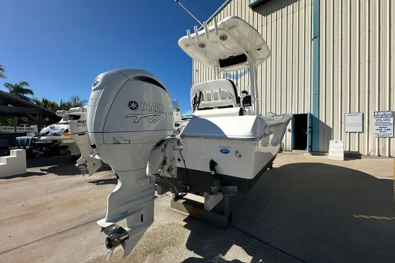 Slide: The Image of 2025 Tidewater 198 CC Adventure boat with Yamaha engine, parked outdoors under clear blue sky. - 3