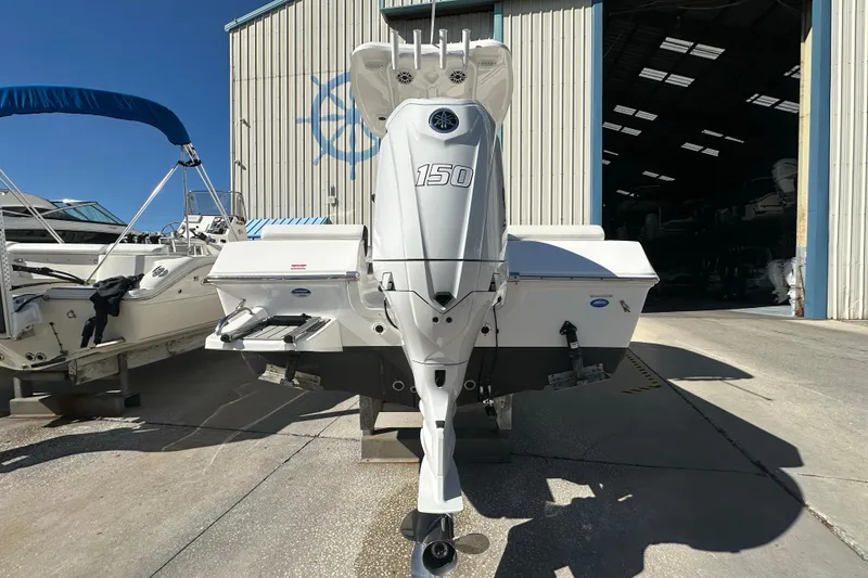 Slide: The Image of 2025 Tidewater 198 CC Adventure boat with 150 HP engine in a marina setting. - 4