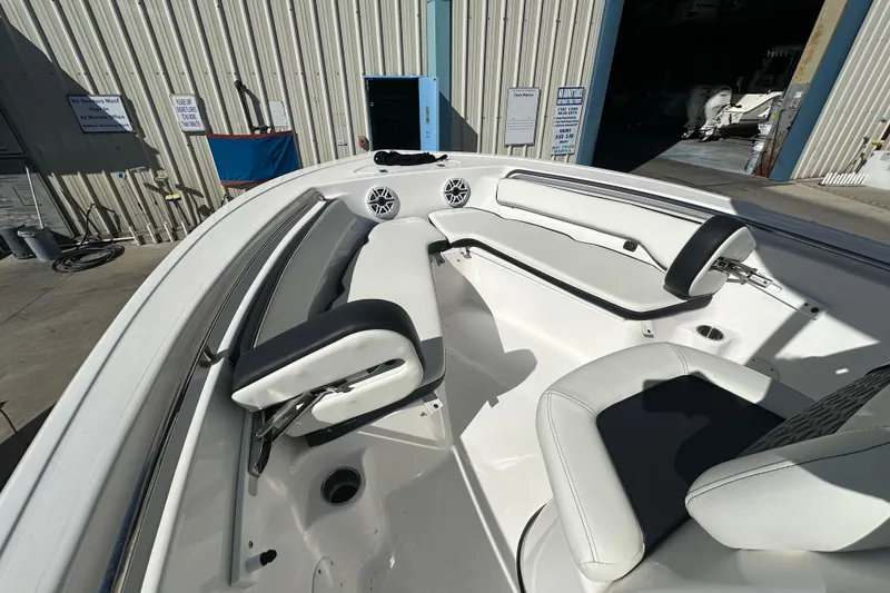 Slide: The Image of 2025 Tidewater 198 CC Adventure boat interior with white seating and speakers. - 9