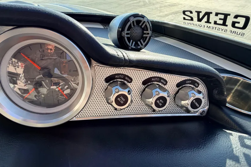 Slide: The Image of Dashboard controls of a 2015 MasterCraft X20 boat with gauges and switches. - 10