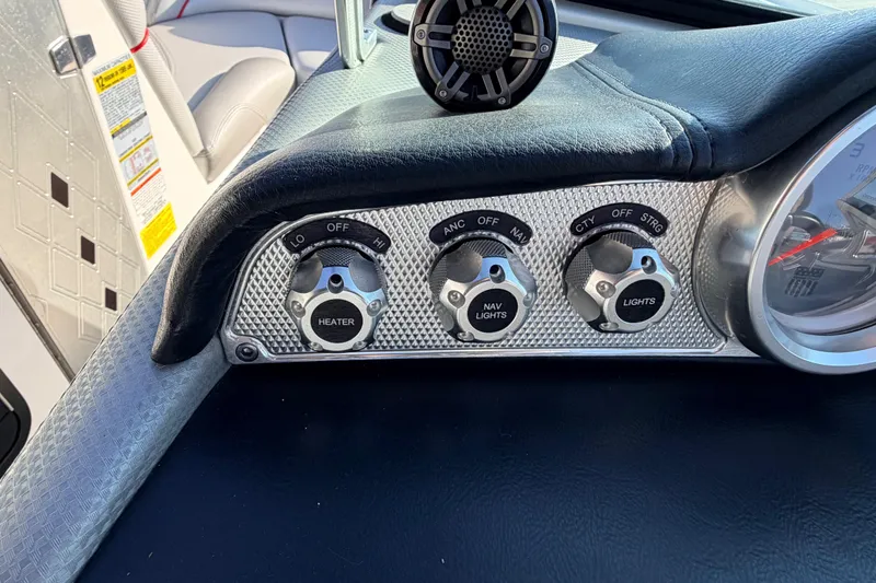 Slide: The Image of Dashboard controls of a 2015 MasterCraft X20 boat, featuring heater and light switches. - 11