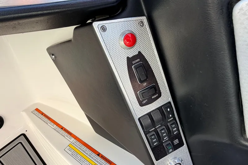 Slide: The Image of Control panel of a 2015 MasterCraft X20 boat with various switches and buttons. - 12