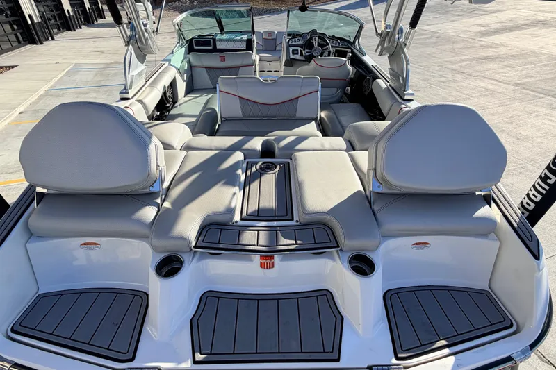 Slide: The Image of 2015 MasterCraft X20 boat interior with gray seating and modern dashboard. - 23