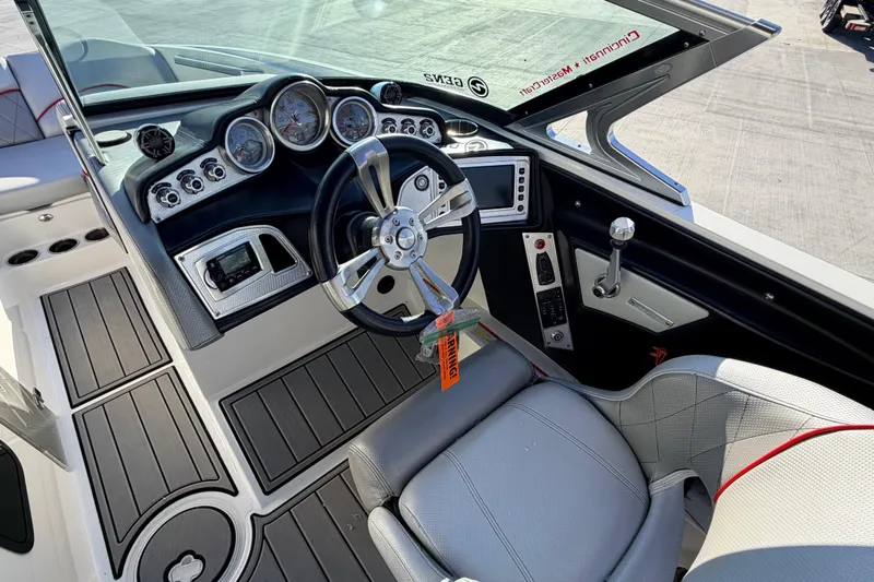 Slide: The Image of 2015 MasterCraft X20 boat cockpit with steering wheel and dashboard controls. - 25