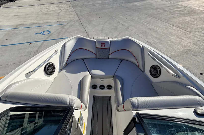 Slide: The Image of 2015 MasterCraft X20 boat interior with gray seating and cup holders. - 29