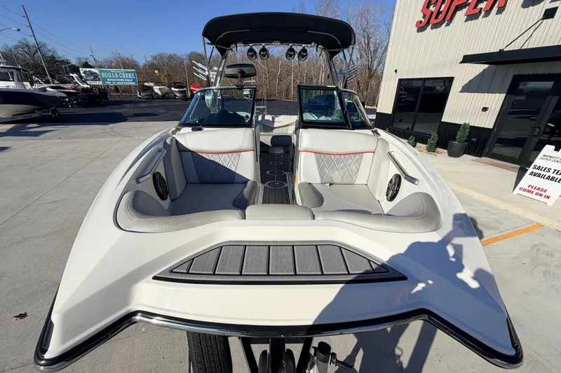 Slide: The Image of 2015 MasterCraft X20 boat with spacious seating, displayed outdoors at a dealership. - 37