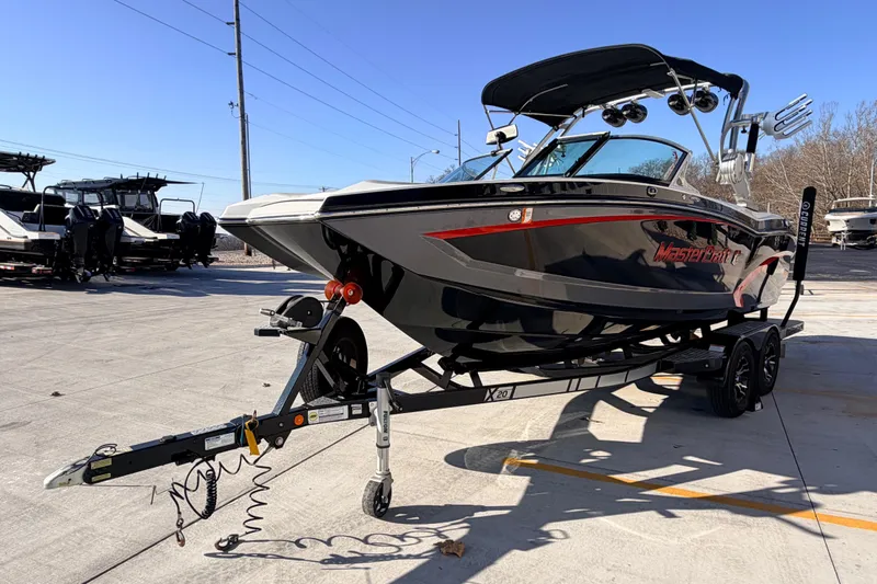 Slide: The Image of 2015 MasterCraft X20 boat on trailer in outdoor setting. - 41