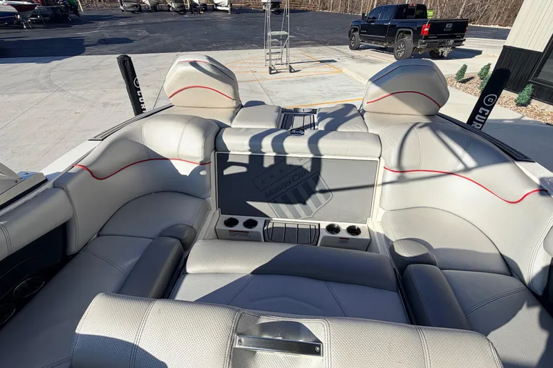 Slide: The Image of 2015 MasterCraft X20 boat interior with gray seating and red accents. - 6