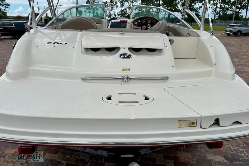 Slide: The Image of 2004 Sea Ray 200 Sundeck boat rear view, parked on brick pavement. - 15