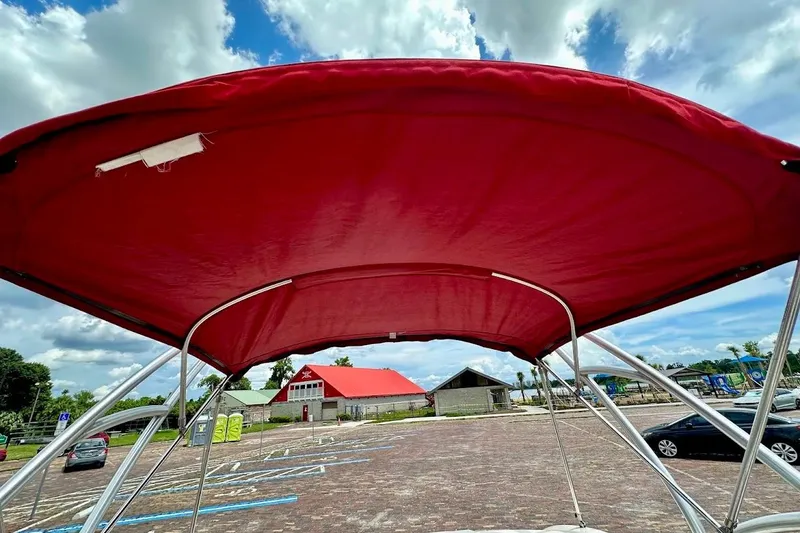Slide: The Image of Red bimini top on 2004 Sea Ray 200 Sundeck, parked in sunny lot. - 18