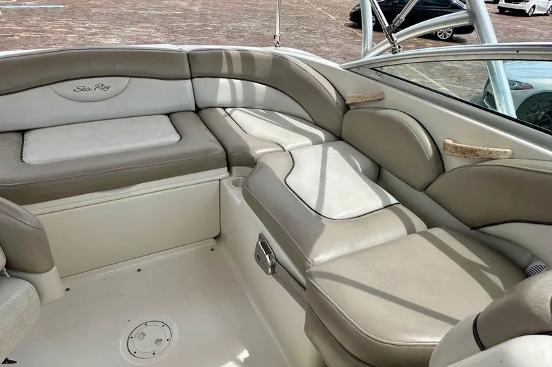Slide: The Image of 2004 Sea Ray 200 Sundeck interior with beige seating and sleek design. - 19