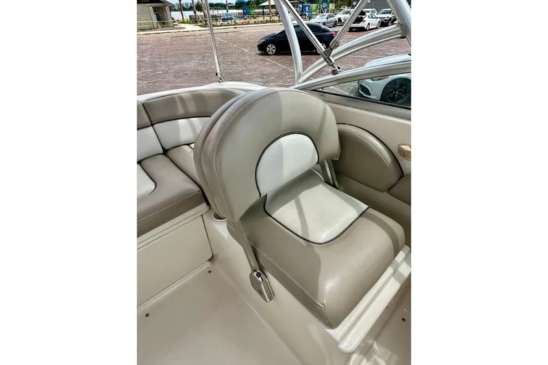 Slide: The Image of 2004 Sea Ray 200 Sundeck interior with beige seating and stainless steel frame. - 20