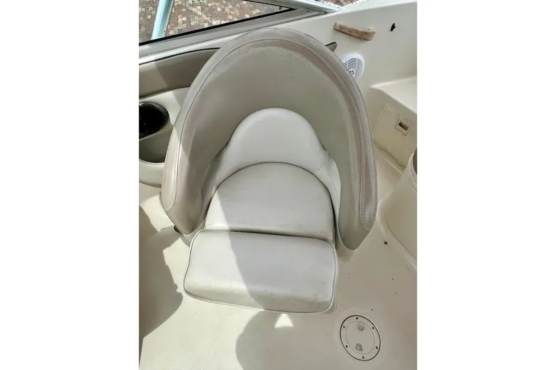 Slide: The Image of 2004 Sea Ray 200 Sundeck boat seat, white and gray upholstery, cup holder visible. - 21