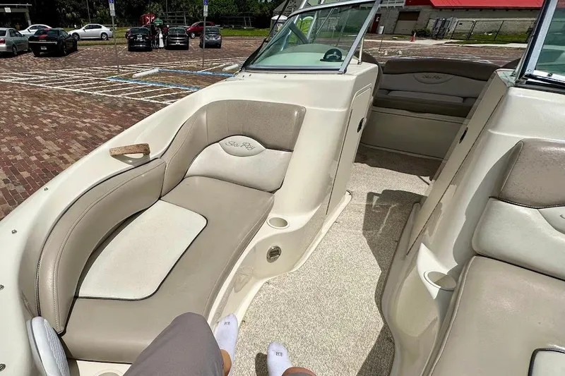 Slide: The Image of 2004 Sea Ray 200 Sundeck interior with beige seating and open deck layout. - 36