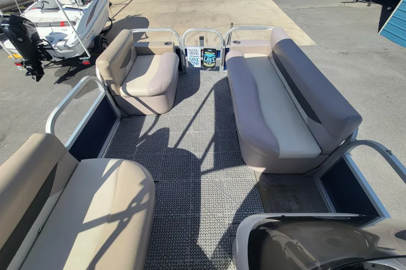 Slide: The Image of 2015 Sun Tracker Party Barge 16 DLX interior with beige seating and open deck layout. - 11