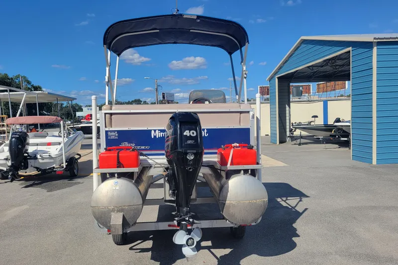 Slide: The Image of 2015 Sun Tracker Party Barge 16 DLX pontoon boat with 40 HP motor, docked outdoors. - 5