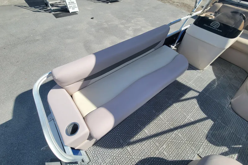 Slide: The Image of 2015 Sun Tracker Party Barge 16 DLX interior with cushioned seating and cup holder. - 8