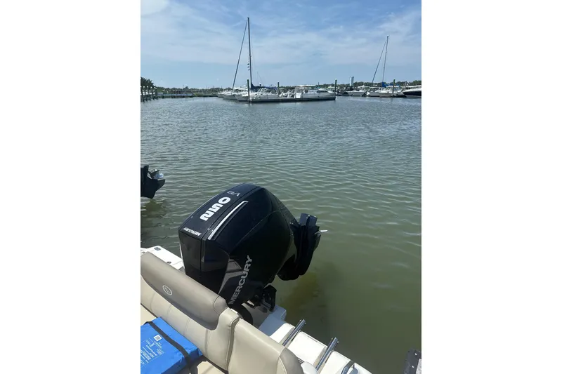 Slide: The Image of 2024 Key West 239 FS boat with Mercury engine docked in a marina. - 11