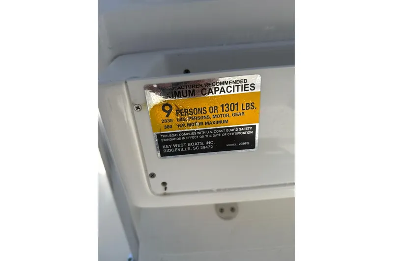 Slide: The Image of 2024 Key West 239 FS capacity label, 9 persons or 1301 lbs, 300 HP maximum. - 12