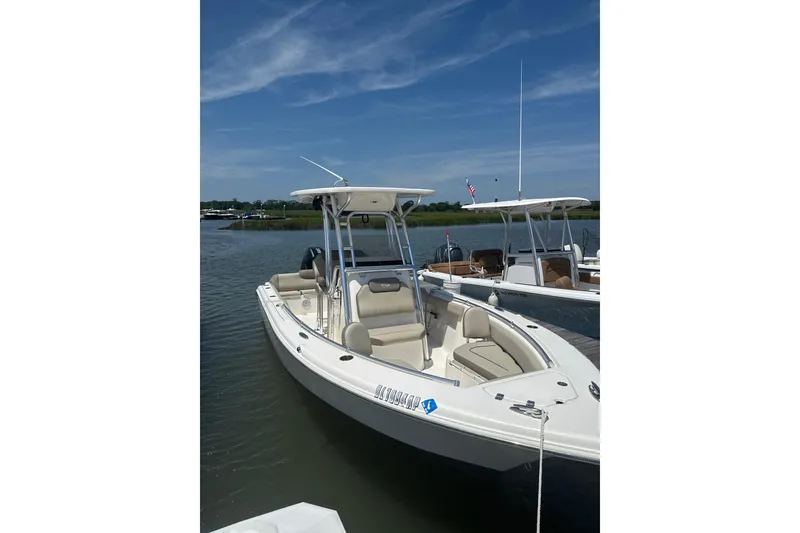 Slide: The Image of 2024 Key West 239 FS boat docked on calm water under a clear blue sky. - 3
