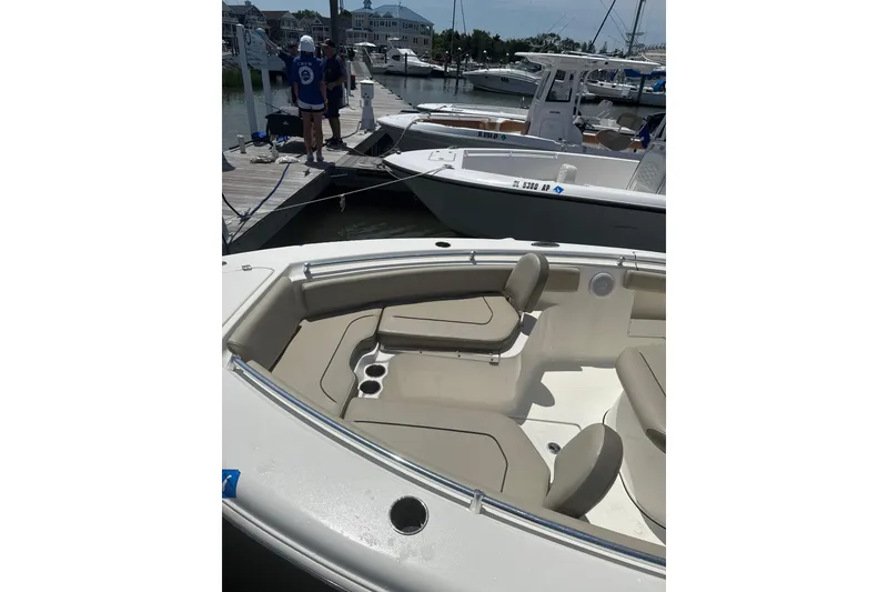 Slide: The Image of 2024 Key West 239 FS boat docked, featuring spacious seating and sleek design. - 4