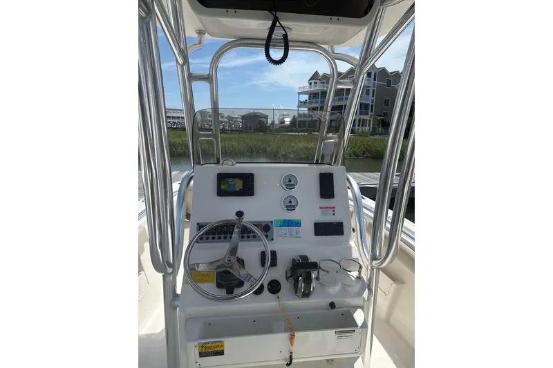 Slide: The Image of 2024 Key West 239 FS boat console with steering wheel and navigation controls. - 8