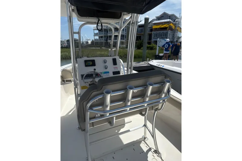 Slide: The Image of 2024 Key West 239 FS boat interior with steering console and rod holders. - 9