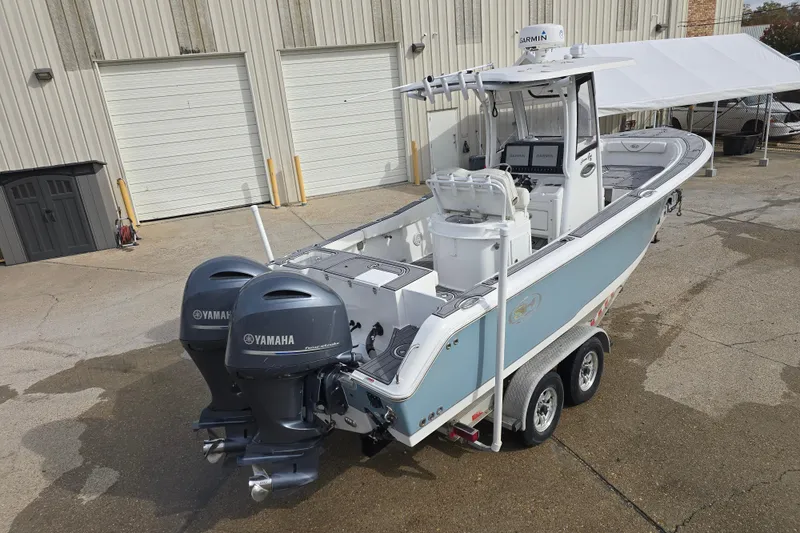 Slide: The Image of 2019 Sea Hunt Gamefish 25 boat with dual Yamaha engines on a trailer. - 11