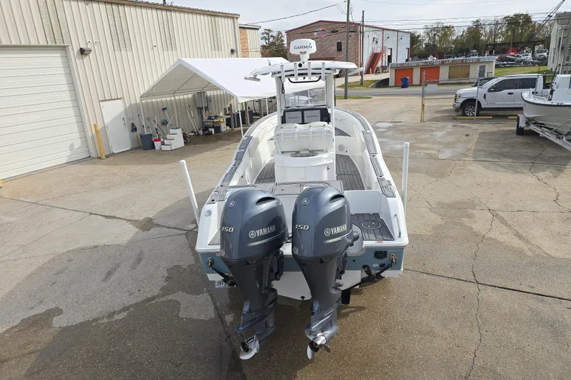 Slide: The Image of 2019 Sea Hunt Gamefish 25 boat with dual Yamaha 150 engines in a marina setting. - 12