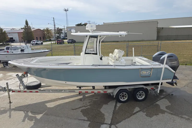 Slide: The Image of 2019 Sea Hunt Gamefish 25 boat on trailer, parked outdoors. - 15