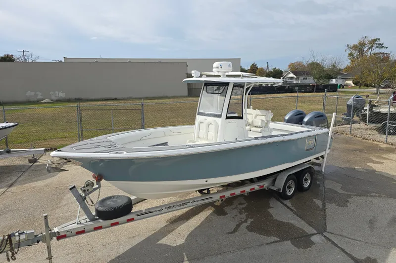 Slide: The Image of 2019 Sea Hunt Gamefish 25 boat on trailer, parked outdoors. - 16