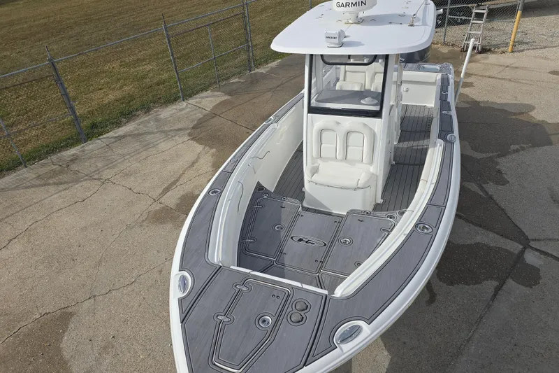 Slide: The Image of 2019 Sea Hunt Gamefish 25 boat with Garmin equipment, docked on concrete. - 17