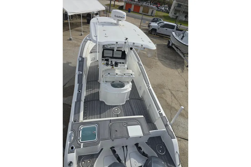 Slide: The Image of 2019 Sea Hunt Gamefish 25 boat with Garmin electronics, docked on concrete. - 19