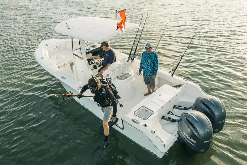 Slide: The Image of 2019 Sea Hunt Gamefish 25 boat with dual Yamaha 150 engines on a trailer. - 2