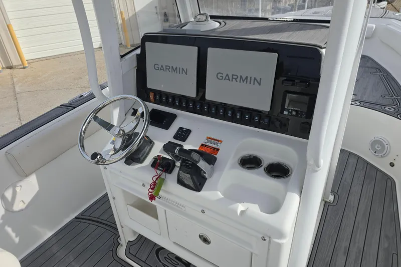 Slide: The Image of 2019 Sea Hunt Gamefish 25 helm with Garmin displays and steering wheel. - 20