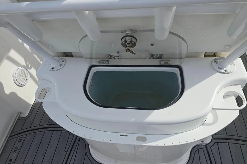 Slide: The Image of 2019 Sea Hunt Gamefish 25 livewell with open lid and rod holders. - 21