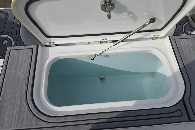 Slide: The Image of Open storage compartment on 2019 Sea Hunt Gamefish 25 boat, featuring a clean interior. - 23