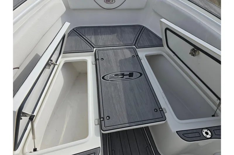 Slide: The Image of 2019 Sea Hunt Gamefish 25 boat storage compartments with open hatches. - 27